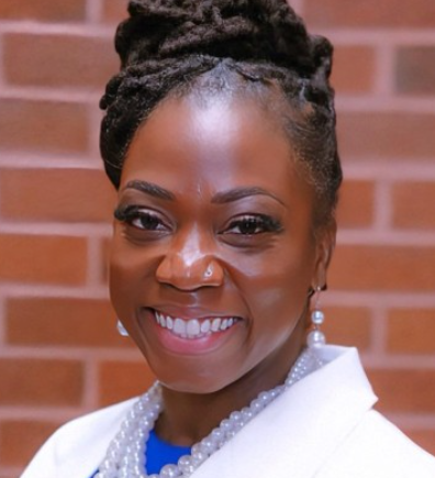 image shows a picture of Dr. Ryce in front of a brick wall.